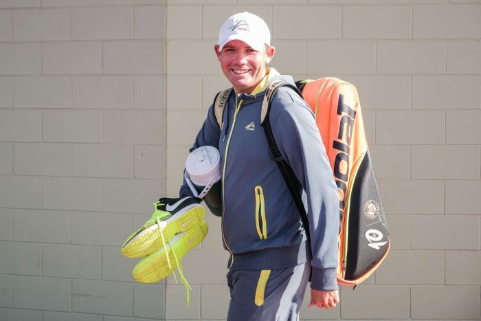 Archie Graham with his racquets and shoes for tennis training.