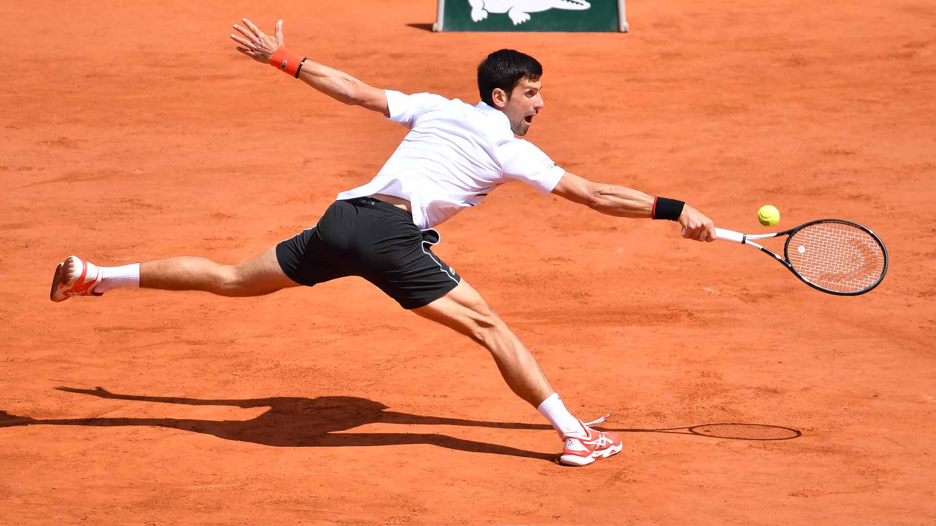 <a href='https://www.atptour.com/en/players/novak-djokovic/d643/overview'>Novak Djokovic</a> hits a backhand in the <a href='https://www.atptour.com/en/tournaments/roland-garros/520/overview'>Roland Garros</a> semi-finals