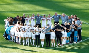 Germany players and coaching staff huddle as they celebrate after the match.