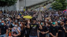 Protesters in Hong Kong Block Road and Surround Police Headquarters