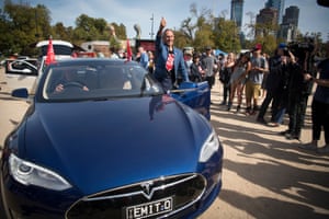 Bob Brown gets into a Tesla electric car in Melbourne that was loaned to him for the Stop Adani convoy