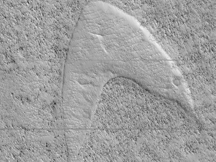 A dune cast, or ghost dune, on Mars that looks strikingly similar to the "Star Trek" Starfleet logo.