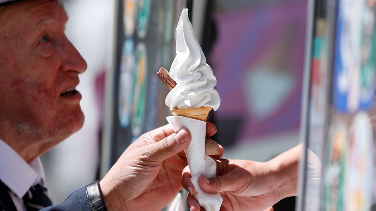 A man buys an ice-cream during warm temperatures in London, Britain, June 29, 2019. REUTERS/Peter Nicholls