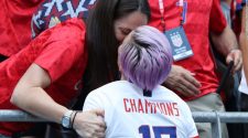 Megan Rapinoe hugs and kisses girlfriend Sue Bird after the Women's World Cup final in Lyon, France.