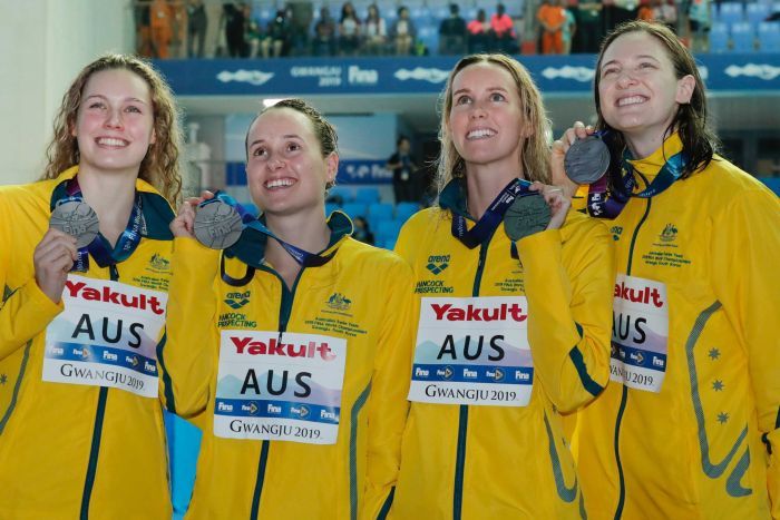 Australia's women's 4x100m medley relay team glance up as they hold their silver medals.