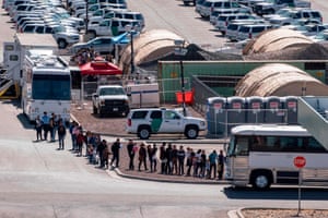 Migrants board buses to take them to shelters after being released from migration detention.
