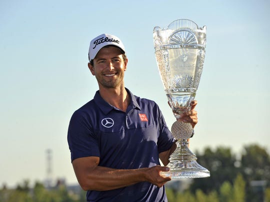 Adam Scott hoists the trophy after winning The Barclays at Liberty National in 2013. The event is now known as The Northern Trust.