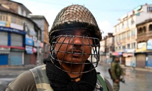 Indian security personnel wear helmets when patrolling Srinagar streets.