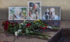 Flowers left in front of photographs of Russian journalists (left to right) Alexander Rastorguyev, Kirill Radchenko and Orkhan Dzhemal, who were recently killed in the Central African Republic, outside the Central House of Journalists in Moscow