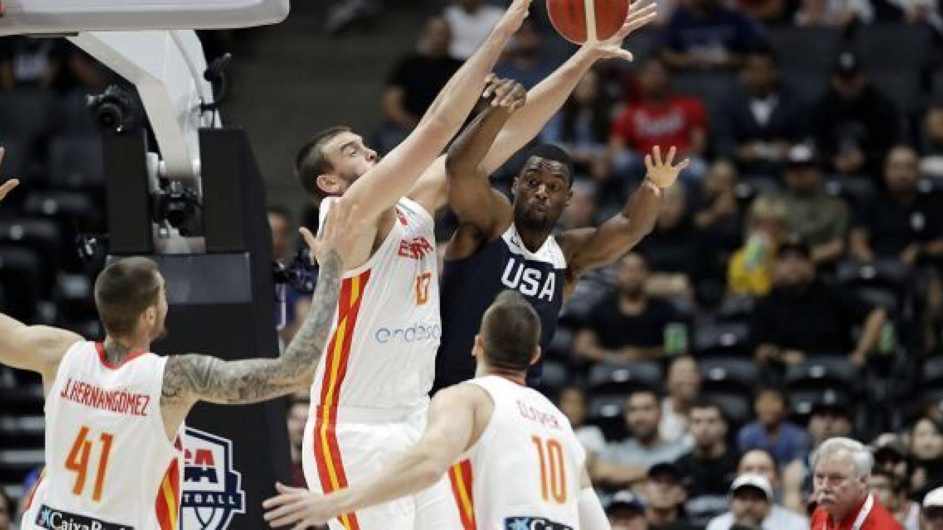 United States' Harrison Barnes, center right, is defended by Spain's Marc Gasol, center left, during the first half of an exhibition basketball game Friday, Aug. 16, 2019, in Anaheim, Calif. (AP Photo/Marcio Jose Sanchez)