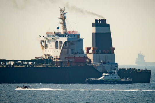 In this July 4, 2019 file photo, a Royal Marine patrol vessel is seen beside the Grace 1 super tanker in the British territory of Gibraltar.