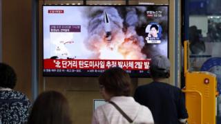 People watch news reports of North Korean projectiles