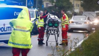Emergency crews are seen near a stretcher after a shooting in the Al-Noor Islamic Centre mosque, near Oslo, on 10 August