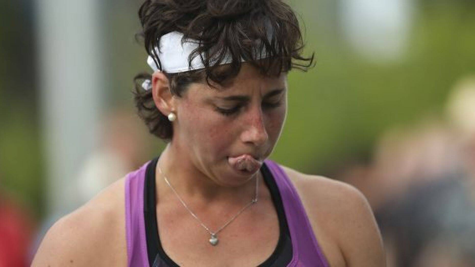 Carla Suarez Navarro, of Spain, reacts after losing a point to Timea Babos, of Hungary, during the first round of the US Open tennis tournament Tuesday, Aug. 27, 2019, in New York. (AP Photo/Eduardo Munoz Alvarez)