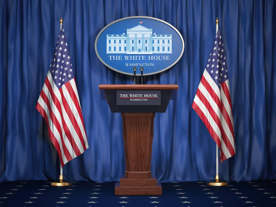 Briefing of president of US United States in White House. Podium speaker tribune with USA flags and sign of White Houise. Politics concept.