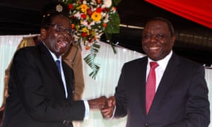 Robert Mugabe as president and Morgan Tsvangirai as prime minister after signing Zimbabwe’s new constitution into law in 2013.