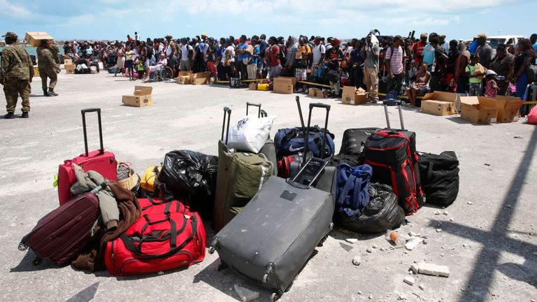 People wait to evacuated in private boats at the Marsh Harbour Port in hurricane devastated Grand Abaco Island on September 6, 2019