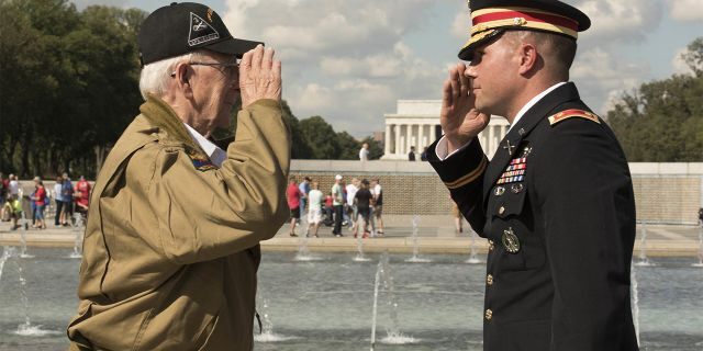 U.S. Army Major Peter Semanoff salutes WWII veteran Clarence Smoyer after awarding him the Bronze Star Medal. (DoD photo by U.S. Navy Petty Officer 2nd Class James K. Lee)