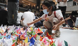 A child arranges origami cranes in the pro-democracy rally at a Sha Tin shopping mall on Sunday