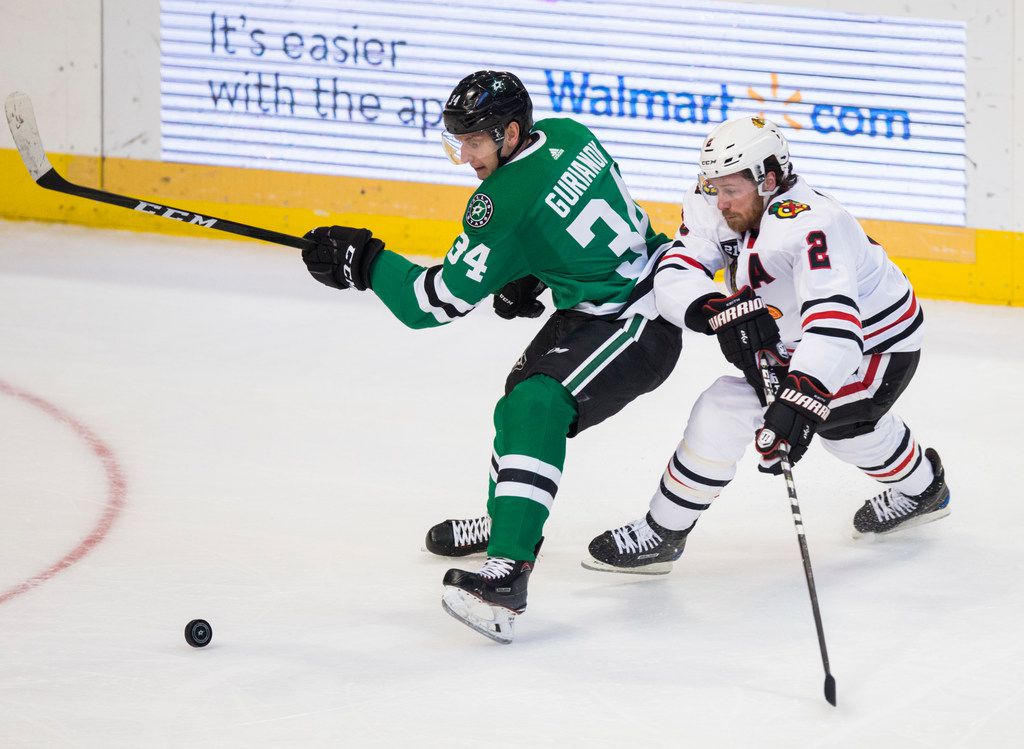 Dallas Stars right wing Denis Gurianov (34) and Chicago Blackhawks defenseman Duncan Keith (2) scramble for the puck during the first period of an NHL game between the Dallas Stars and the Chicago Blackhawks on Thursday, December 20, 2018 at American Airlines Center in Dallas. (Ashley Landis/The Dallas Morning News)