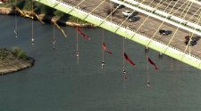 Greenpeace activists suspend themselves from Houston's Fred Hartman Bridge to protest fossil fuel