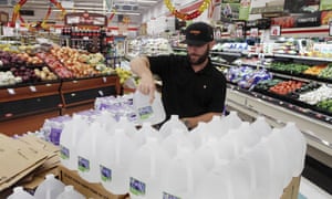 Chris Creel, manager of Piggly Wiggly, stocks pallets of bottled water as grocery customers prepare for the arrival of storm weather with Hurricane Dorian in New Bern, North Carolina.