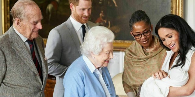In this image made available by SussexRoyal on Wednesday, May 8, 2019, Britain's Prince Harry and Meghan, Duchess of Sussex, joined by her mother Doria Ragland, show their new son to Queen Elizabeth II and Prince Philip at Windsor Castle, Windsor, England. Prince Harry and Meghan have named their son Archie Harrison Mountbatten-Windsor.