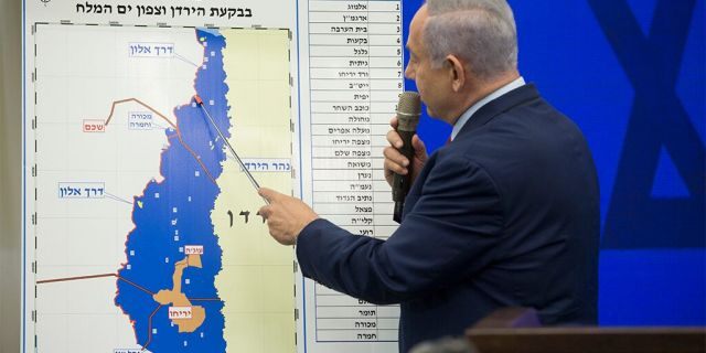 Israeli Prime Minster Benjamin Netanyahu points to a Jordan Valley map during his announcement on Tuesday in Ramat Gan, Israel. Netanyahu pledged to annex Jordan Valley in Occupied West Bank if reelected after the Sept. 17 Israeli elections. (Getty Images)