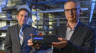 Professor of Chemistry Alexander Star, left, and associate professor of electrical and computer engineering Ervin Sejdic, pose with the prototype of the THC Breathalyzer developed using their interdisciplinary research. Current testing methods for tetrahydrocannabinol (THC), the psychoactive compound in marijuana, rely on blood, urine or hair samples and cannot be done in the field. The prototype works similar to a breathalyzer for alcohol, with a plastic casing, protruding mouthpiece and digital display.