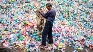 A Chinese worker sorting out plastic bottles for recycling on the outskirts of Beijing.