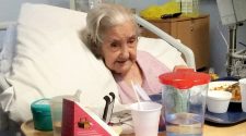 Emily Sims. A 101-year-old woman died after she was swung out of bed by a care worker, breaking both her legs, an inquest heard