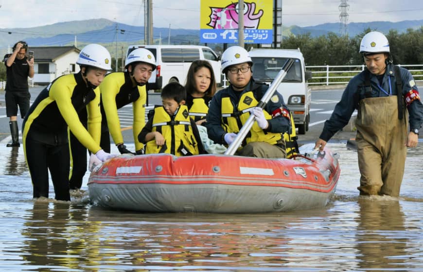 Emergency workers rescue residents in a flooded residential area in Iwaki, Fukushima Prefecture. | KYODO