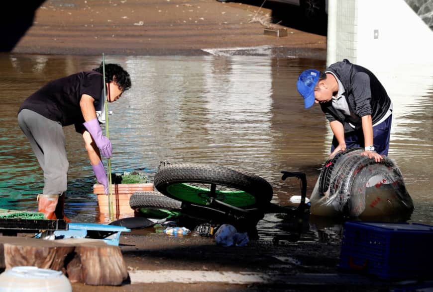 Clean-up begins in a flooded residential area in Kawasaki. | REUTERS