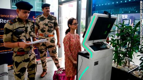 A passenger stands as she registers her personal details at a facial recognition counter at the Rajiv Gandhi International Airport in Hyderabad, on July 26, 2019. 