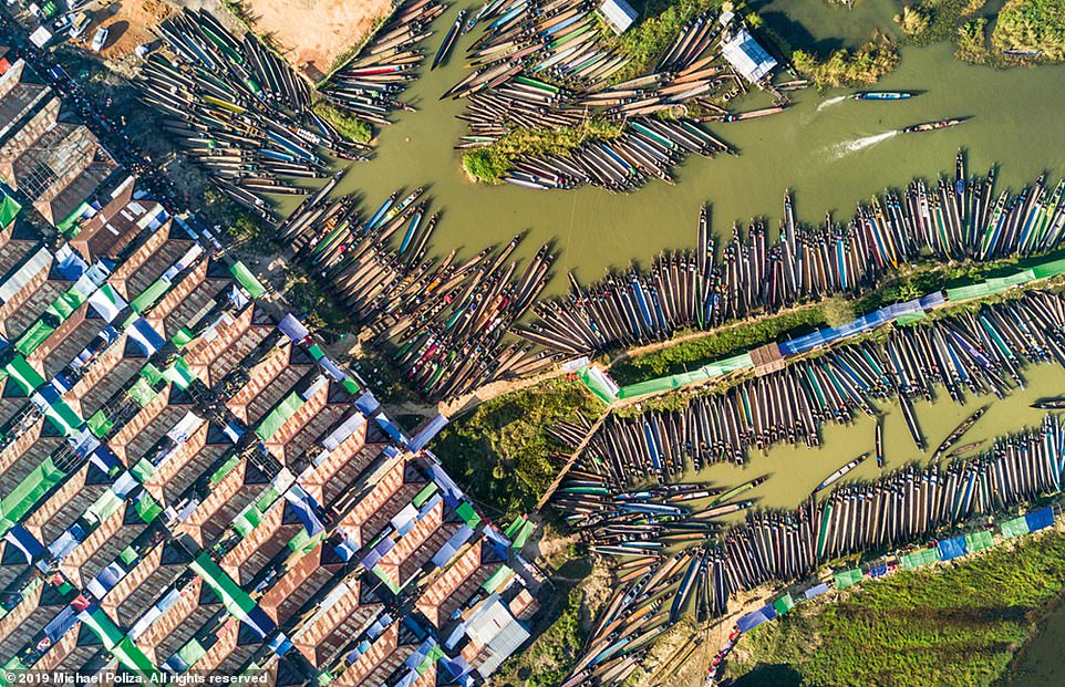 This stunning aerial shot shows longboats at a market in the village of Nampan on Inle Lake in Myanmar's Shan State. The remarkable village is built on stilts over the water