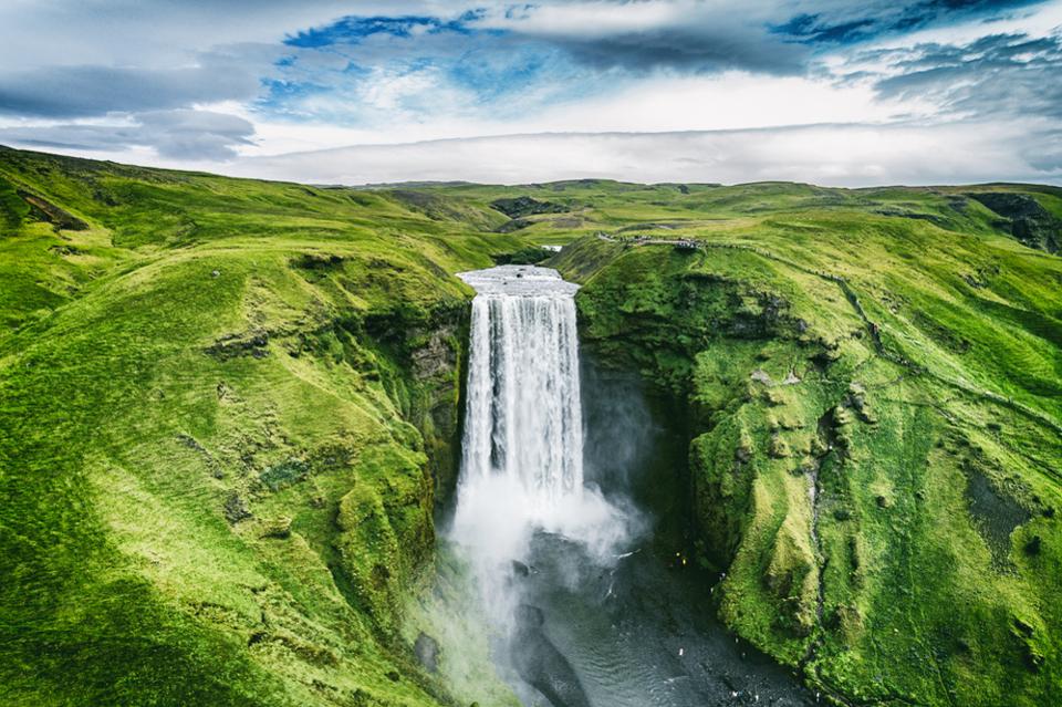 Tourists in Iceland love Skógafoss.