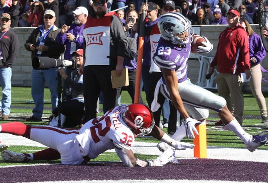 Kansas State Wildcats wide receiver Wykeen Gill gets past Oklahoma Sooners safety Delarrin Turner-Yell (32) into the end zone for a touchdown.