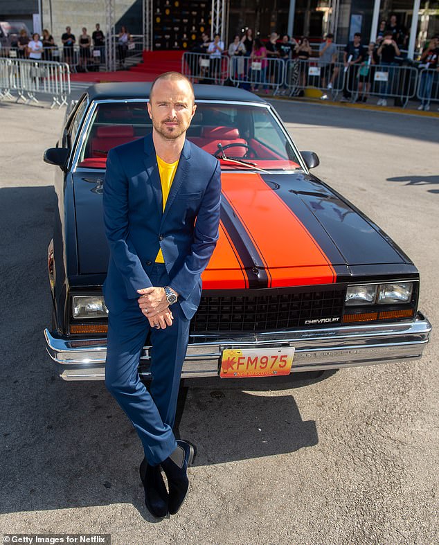Handsome: Aaron Paul looked sharp in a blue suit and yellow shirt as he made a stylish entrance at the El Camino: A Breaking Bad Movie premiere in Spain on Saturday