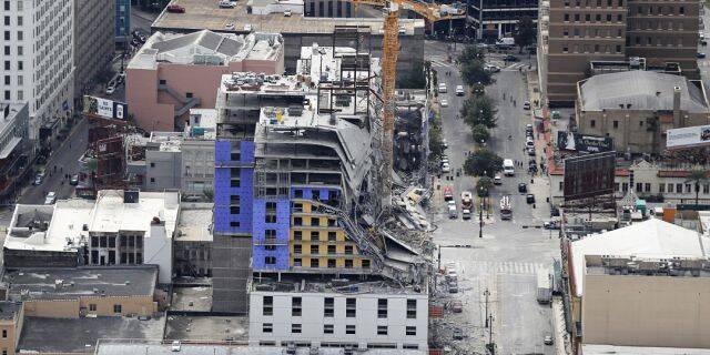 This aerial photo shows the Hard Rock Hotel, which was under construction, after a fatal partial collapse in New Orleans, Saturday. Officials said two damages cranes are hampering rescue efforts to locate a missing worker. (AP Photo/Gerald Herbert)
