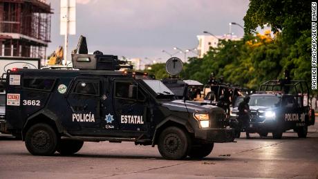Mexican police patrol in a street of Culiacan after heavily armed gunmen fought an intense battle with Mexican security forces. 