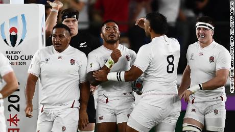 England&#39;s Manu Tuilagi (C) celebrates with teammates after scoring the first try.