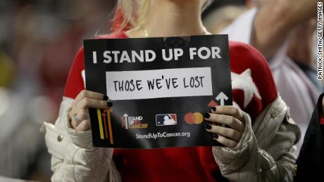 A fan holds up a Stand Up To Cancer sign before the sixth inning in Game 4 of the 2019 World Series. 