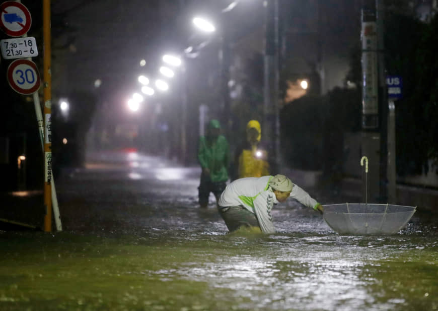Roads are flooded due to heavy rains caused by Typhoon Hagibis in Tokyo's Setagaya Ward on Saturday. | KYODO