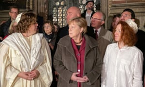 German chancellor Angela Merkel, centre, stands with Rabbi Gesa S Ederberg, left, and other members of the Jewish community at the New Synagogue in Berlin
