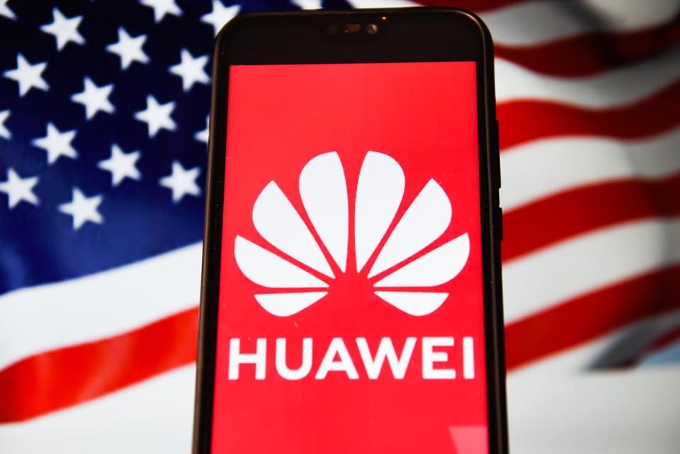 In this photo illustration a Huawei logo seen displayed on a...