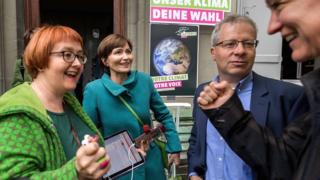 Swiss Green Party president MP Regula Rytz (2nd L) reacts with party members at their meeting place waiting for the first results during the general election in the Swiss capital, Bern.