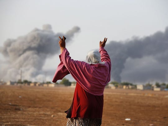 Kiymet Ergun, a Syrian Kurd, gestures as she watches