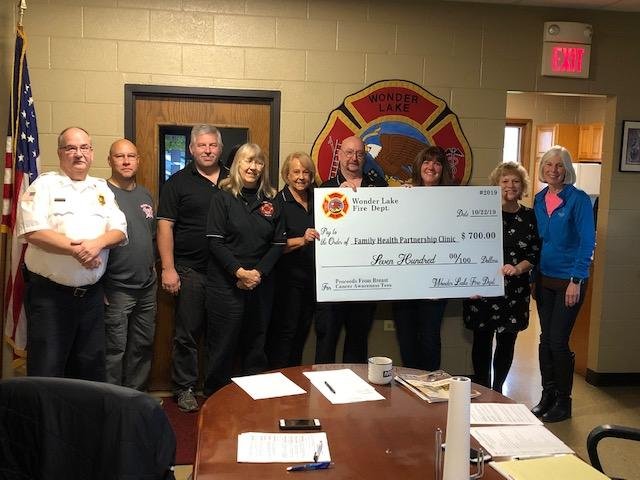 The Wonder Lake Fire Department Board of Trustees on Tuesday presented a $700 donation to the Family Health Partnership Clinic. Members of the department sold breast cancer awareness shirts for Breast Cancer Awareness Month in October to raise the money. The department said it chose Family Health Partnership Clinic as the recipient because the clinic helps the uninsured men and women of McHenry County have access to mammograms. The group hopes to double its donation next year. Pictured are Fire Chief Mike Weber (from left); Trustees Todd Rishling, Steve Young, Cheryl Hammerand, Barb Klasen and Ray White; administrative assistant Laurie Busse; and Suzanne and Kathy from the Family Health Partnership Clinic.