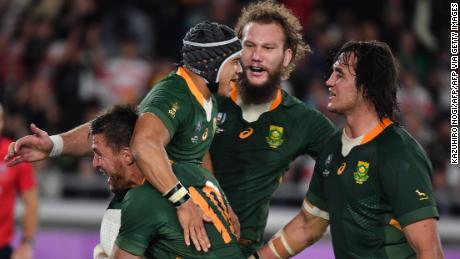 South Africa&#39;s wing Cheslin Kolbe (C) is congratulated by teammates after scoring a try against England.