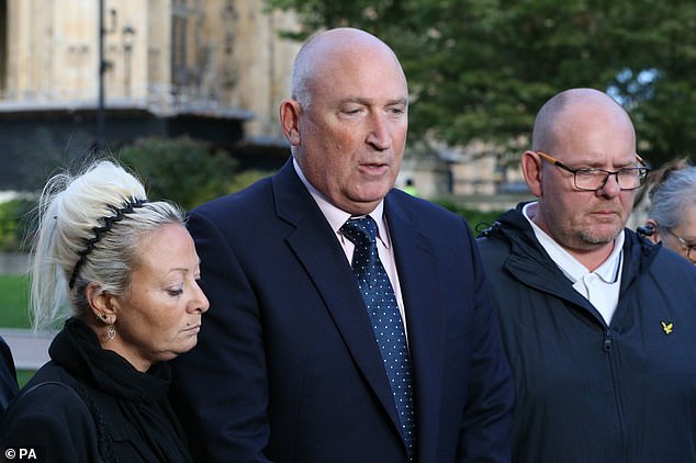 Pictured: Harry's mother Charlotte Charles, family spokesman Radd Seiger and his father Tim Dunn outside the Foreign and Commonwealth Office on October 9